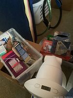 White Bioptron light therapy device next to plastic container with medical supplies