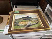 Two acrylic on board paintings by C.H. Birkhead framed in matching ornamental brown and gold frames, lying flat in a drawer.