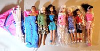 Full lot of seven dolls and tent materials laid side by side on floor.