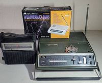 Photo shows all three radios: General Electric vintage portable radio, Zenith traffic cassette player/radio, and boxed Midland Weathermax Plus weather radio.
