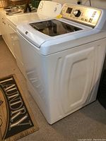 Washer and dryer side by side in basement laundry area