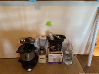 Photo showing air fryer, blender, food processor, electric waffle maker, and Rival ice cream maker box.