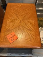 Close-up top view of one wooden TV tray showing the wood grain pattern and rounded edges.
