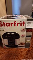 Front view of the Starfrit pressure cooker box showing brand name, model, and product image.