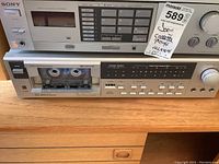 Front view of Sony receiver and cassette player showing the various buttons and cassette compartment with tape inside.