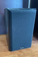 Front view of Infinity stereo speaker with black cloth grille and Infinity logo