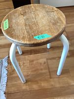 Round wooden stool with white powder coated metal legs