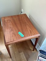 Teak side table showing top, legs and wood grain detail