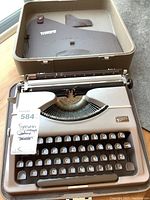 Top view of vintage Gossen Tippa typewriter showing QWERTZ keyboard layout and original seller tag.
