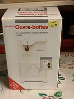 Boxed Sunbeam electric can opener showing front and top sides with price tags.