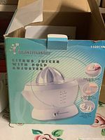Box of Toastmaster Citrus Juicer with Pulp Adjuster, showing product image and product features on box.