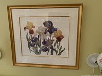 Full view of framed floral watercolor painting on the wall.