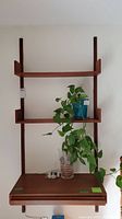 Front view showing full shelving system mounted with three shelves and bottom desk shelf