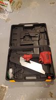 28 inch Worksite framing nailer inside black hard molded plastic carrying case with compartments.
