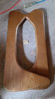 Pair of wooden coffee table legs shaped in Noguchi style, showing walnut stained finish and smooth contours.