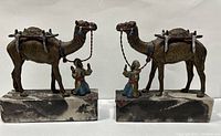 Front angle of both antique brass camel and rider bookends, showing detailed paint and marble bases