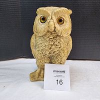 Front view of hand carved stone owl showing detailed feathers, textured base, and distinct eyes.