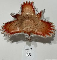 Top-down view of large Italian Murano glass leaf bowl showing orange center with gold sparkles and white and clear glass edges.