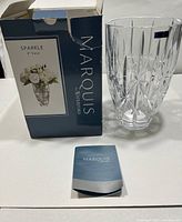 View showing the 9 inch Marquis by Waterford crystal vase with original box and booklet.