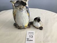 Photo of pottery owl sculpture and detached head on a light-colored surface with MaxSold lot card visible