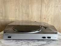 Full view of Ion USB Turntable with clear dust cover closed, placed on marble surface.