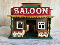 Front view of wooden saloon model with saloon and whisky signs.