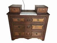 Full front view of antique dresser showing all drawers and marble top insert.