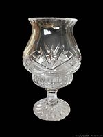 Clear cut glass fairy light piece showing geometric and starburst cut patterns, pedestal base, viewed from the side.