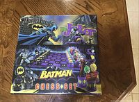 Front view of Batman Chess Set box showing Batman vs Joker themed chess pieces and board.