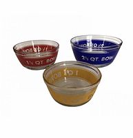 Image showing three vintage Anchor Hocking glass mixing bowls in nesting formation, colored yellow (1 qt), red (1.5 qt), and blue (2.5 qt) with printed measurement markings.