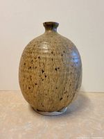 Front view of ovoid vessel showing overall shape and speckled glaze
