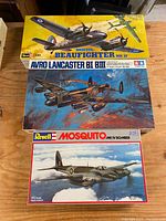 Three boxed vintage airplane model plastic kits stacked: Bristol Beaufighter MK.IF, Avro Lancaster BI BIII, and Revell Mosquito MK IV Bomber.