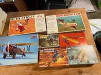 Photo of six vintage model airplane kits with colorful vintage box artwork including Gee Bee R-1 Racer, Wedell-Williams Racer, Boeing P-12E, Avro and Bristol 1911 scale kits.