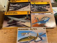 Five vintage model airplane kits with box art showing German WWII planes, labeled with brands and models.