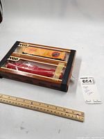 Two Tyco Coca Cola HO scale trains in original box packaging. Visible yellow boxcar and red tanker car. Wooden ruler for scale and MaxSold lot tag included.
