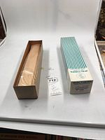 Photo showing open plain cardboard box with the kit wrapped in protective paper next to outer Walthers striped box.