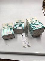 Four sealed boxes of Walthers Pullman wheel trucks on a white background with an auction tag.