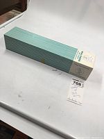 View of entire sealed box with striped green and white packaging