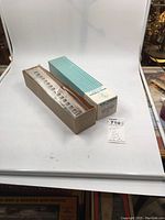 Opened box with visible plastic model parts inside a clear plastic blister and original striped cardboard sleeve.