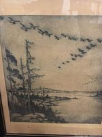 Close-up of etching artwork showing shoreline with birds in flight