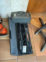 Closed hard case with handle and latches showing Yamaha WX7 label