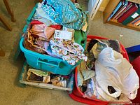 Three plastic bins filled with diverse crafting fabrics in various colors and patterns