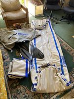 Full view of deflated Sea Eagle SE 370 inflatable kayak laid out on floor with carrying bag, paddles, and inflatable seat.