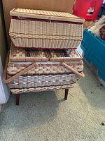 Similar front view showing top box lid open, woven wicker texture and legged base of bottom box