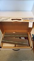 The Ultimate Sweater Machine needle beds in original box.