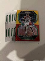 Five Boston Celtics Reggie Lewis NBA trading cards with Panini Prizm branding, showing front card with colorful border and action image of Reggie Lewis in Celtics uniform.