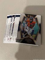 Stack of Denver Broncos Select NFL trading cards with a Javonte Williams rookie card on top.
