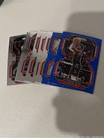 Photo showing 10 Houston Rockets NBA basketball cards fanned out, including base and colored parallel cards.