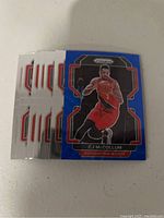 Photo of 9 Portland Trail Blazers basketball cards showing a blue Prizm card featuring CJ McCollum at the front.