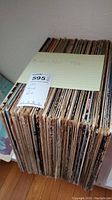 Stack of vintage vinyl records with handwritten labels 'Rock & Roll Folk'. Records show wear and age on sleeves.